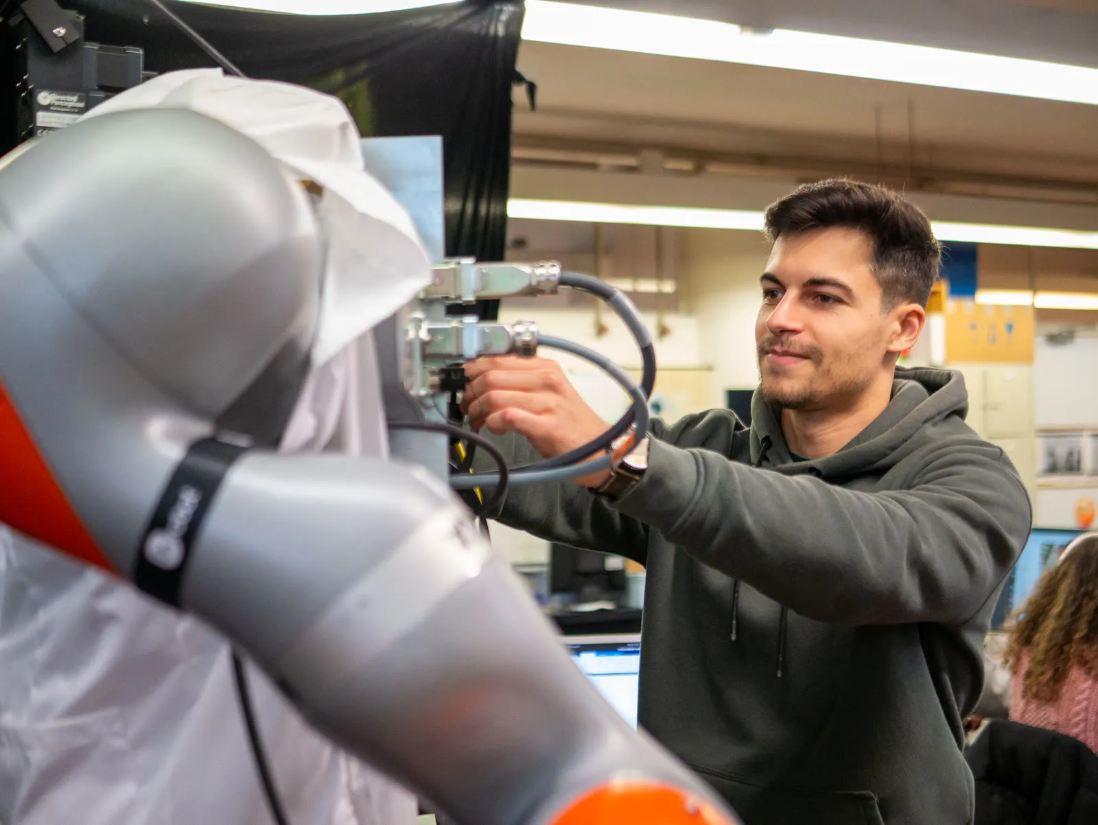 João Gaspar Cunha working on a robot arm